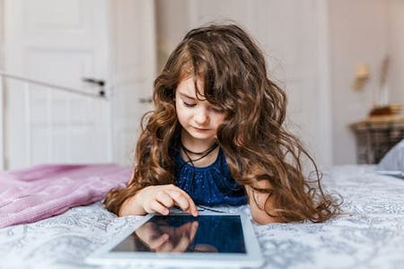 Child Chatting with an AI Chatbot on a Tablet